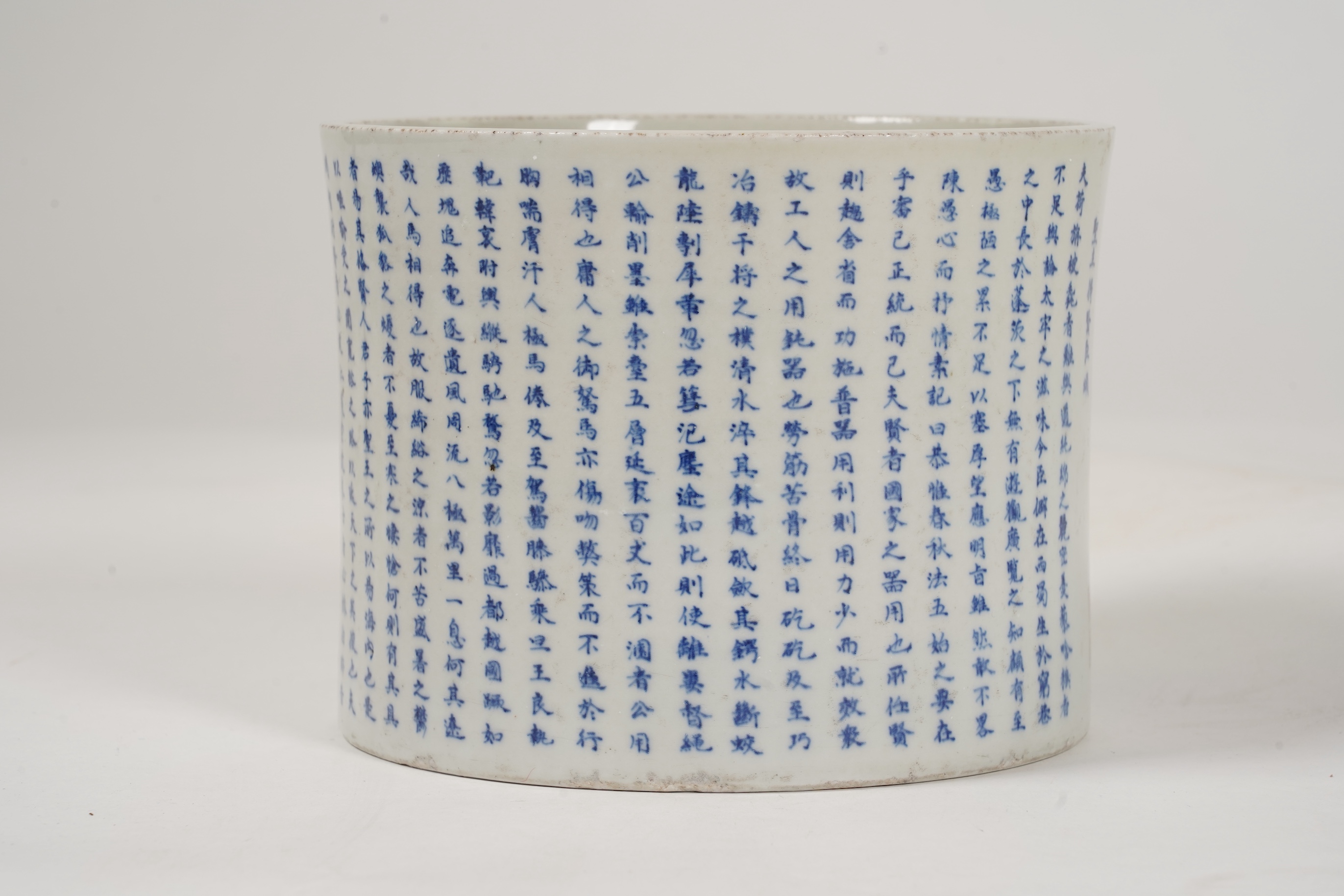 A Chinese underglaze blue and copper red inscribed brush pot, possibly Kangxi period